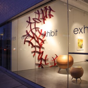 Curves 8 (red wall sculpture) and Spheres (round tables)