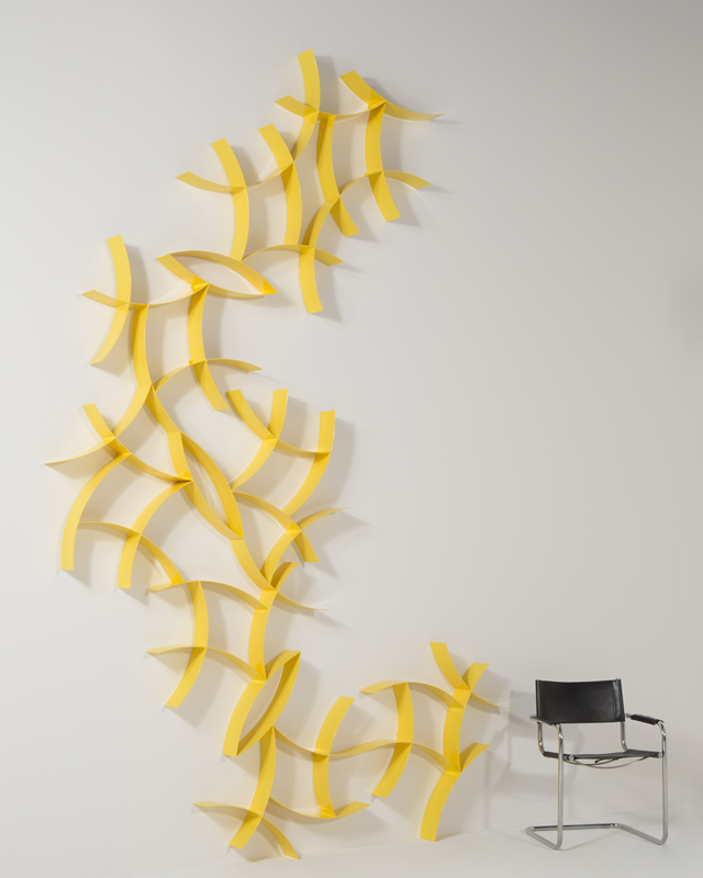 yellow metal wall sculpture