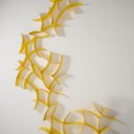 Yellow wall hanging sculptures by Morgan Robinson